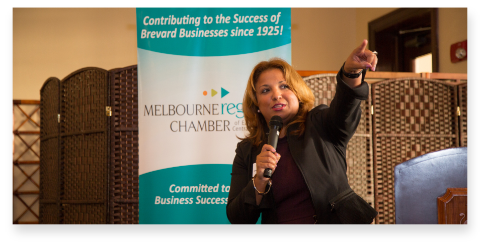 Woman speaking into microphone at a Melbourne Regional Chamber event