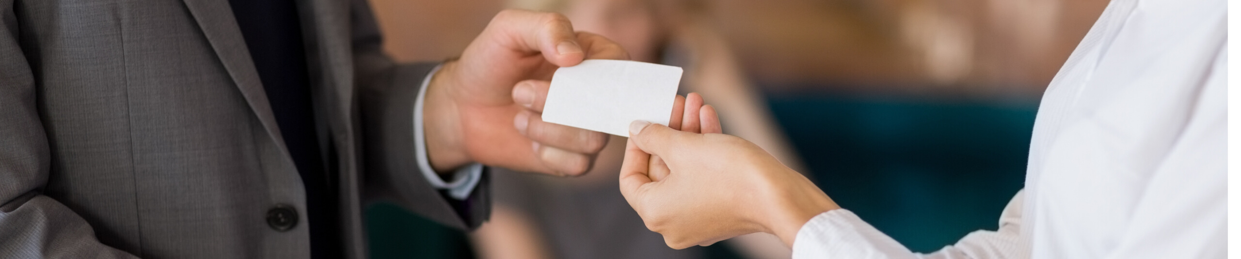 Male handing female a business card