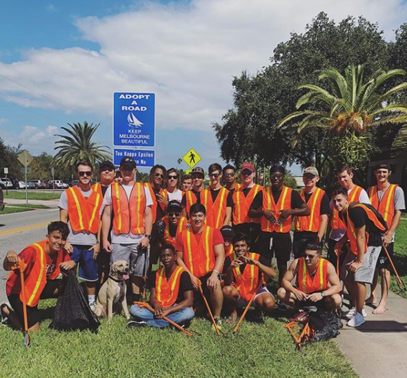 Group of men smiling for a photo after picking up litter for the City of Melbourne